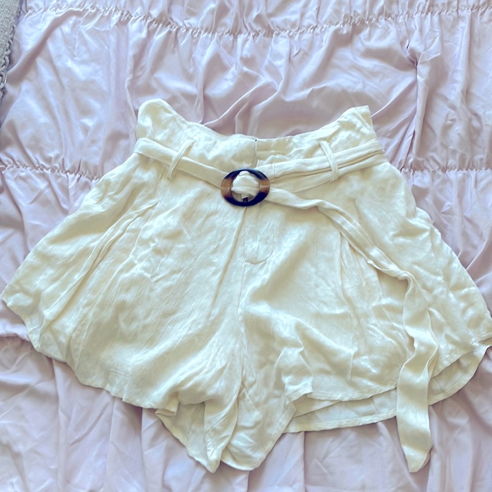 The brand is Forever 21, the color is a yellowish cream and its a size M